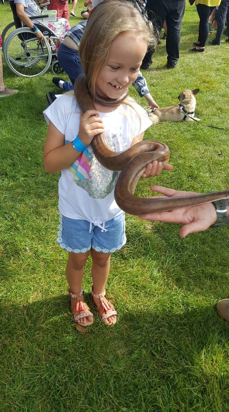Young girl with snake around her neck